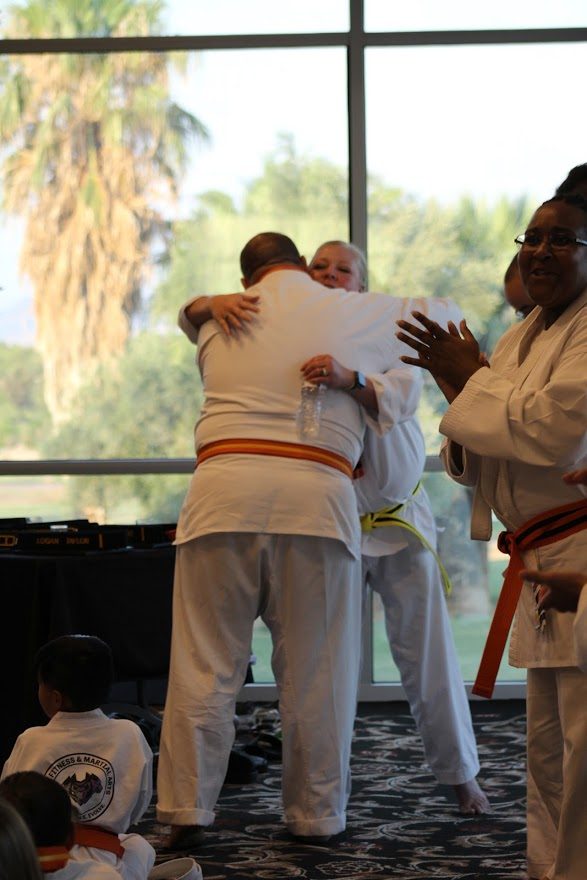 Students hugging after a belt ceremony at CORE Fitness & Martial Arts in Henderson