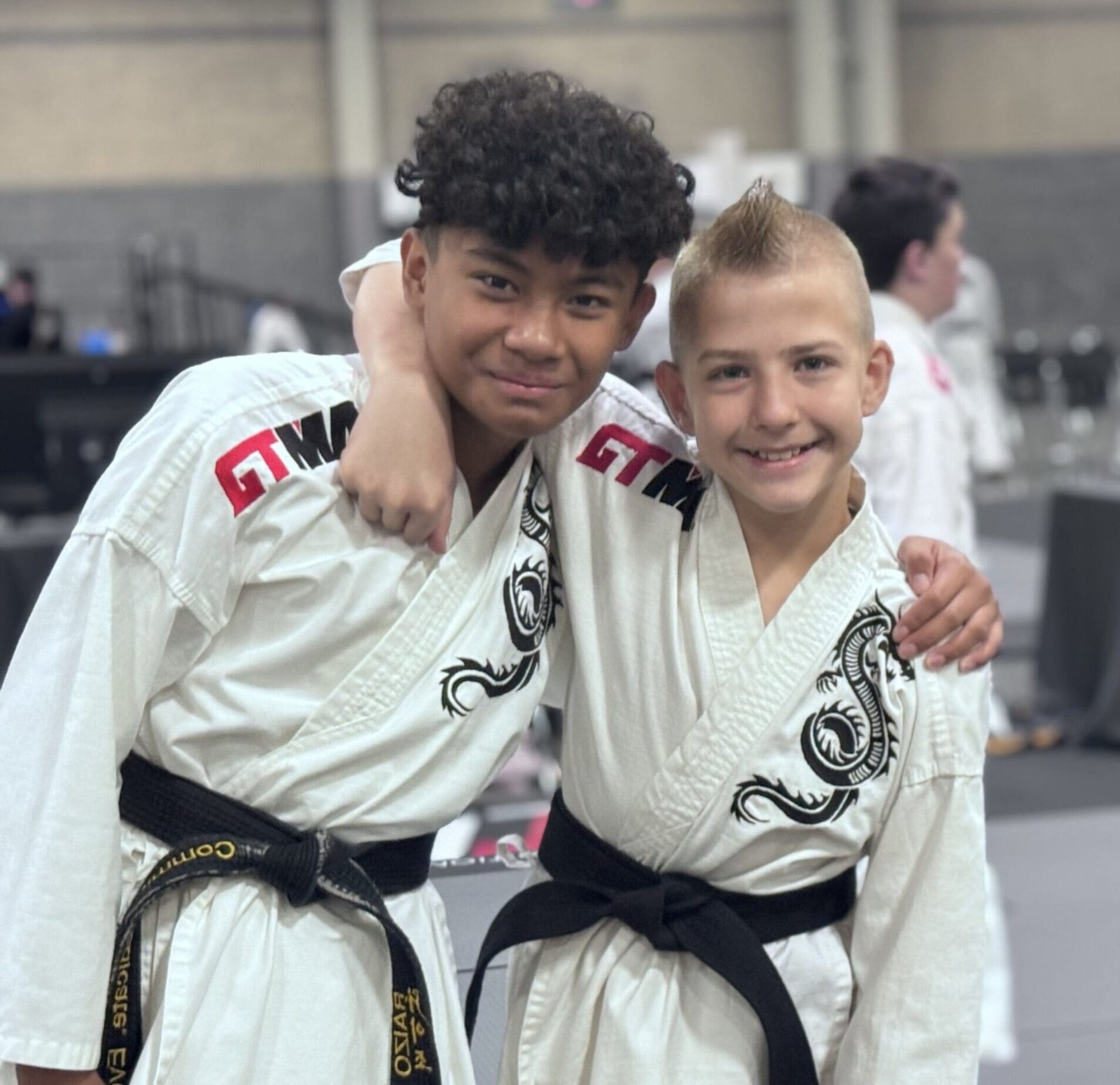 Two young black belts with their arms around each other at CORE Fitness & Martial Arts in Henderson