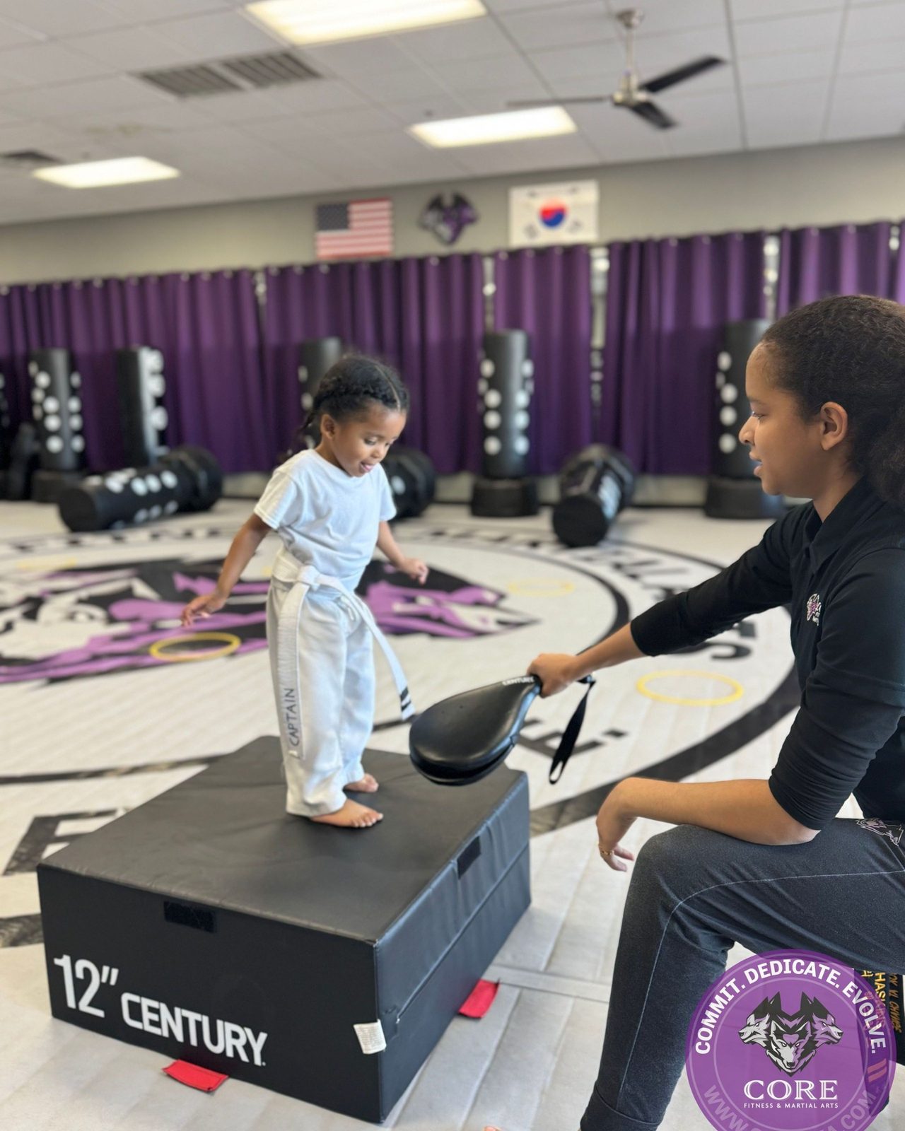 A Wolf Pup punching a boxing pad at CORE Fitness & Martial Arts in Henderson