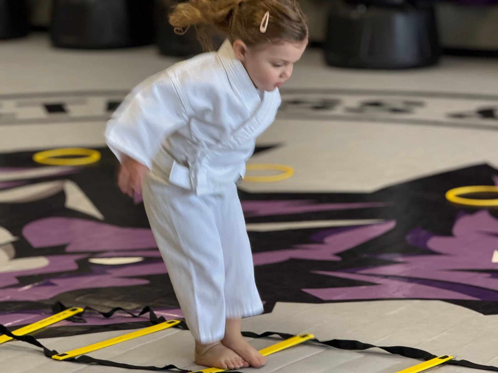 A Wolf Pup running an agility ladder at CORE Fitness & Martial Arts in Henderson