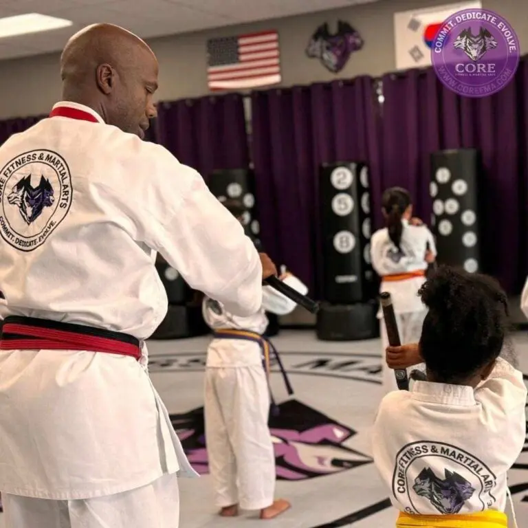 Family martial arts academy group during belt promotion ceremony